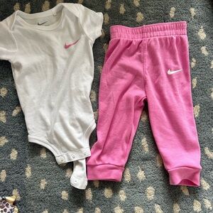 Nike White Baby Bodysuit with Pink Swoosh